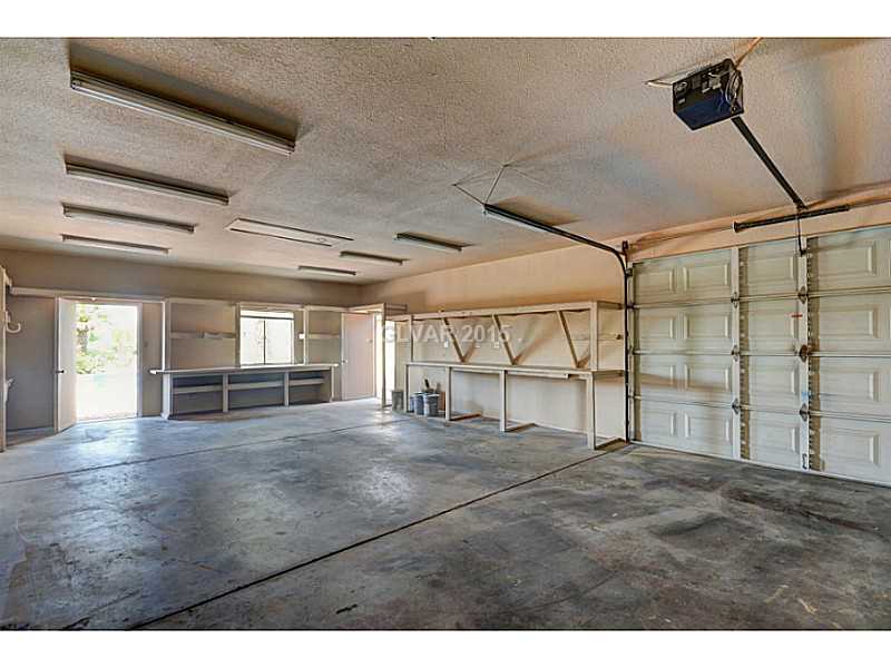 416 Blackridge Road Henderson, NV 89015 - Photo 33 of 35 Property Photo. 3 car garage with workshop and work bench and 9 foot tall door.