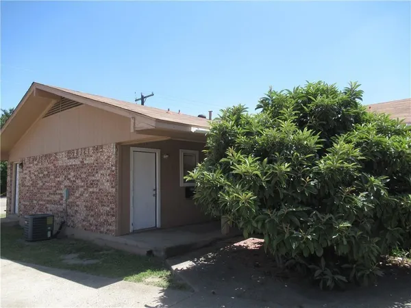 a house with a tree in front of it