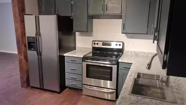 a kitchen with a stove microwave and refrigerator