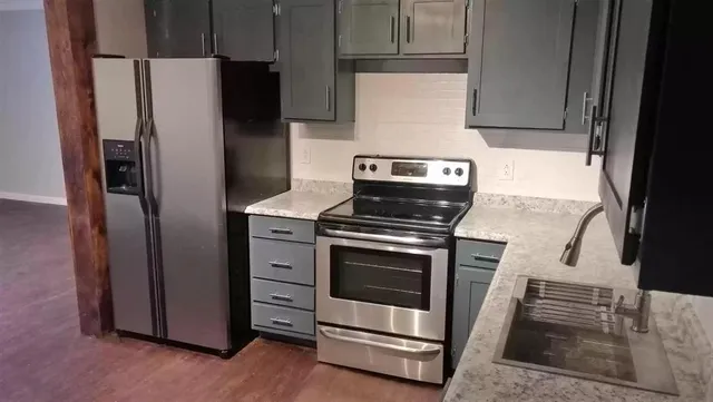 a kitchen with a stove microwave and refrigerator