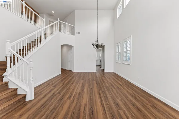a view of a livingroom with wooden floor and a fireplace