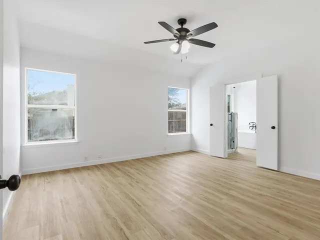 a view of a livingroom with a fireplace and window
