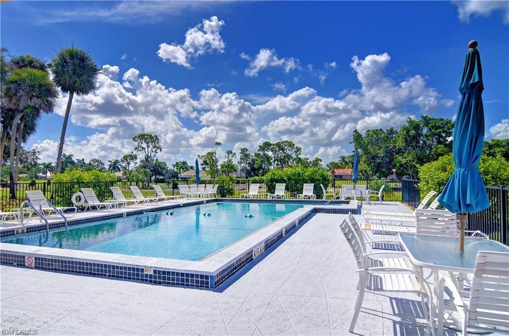 5635 Rattlesnake Hammock Road, Unit D203 Naples, FL 34113 - Photo 11 of 23 Community pool with a patio
