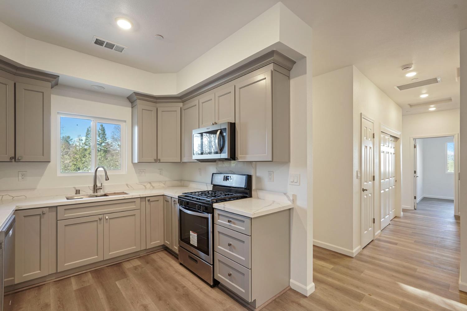 a kitchen with a sink stove and cabinets