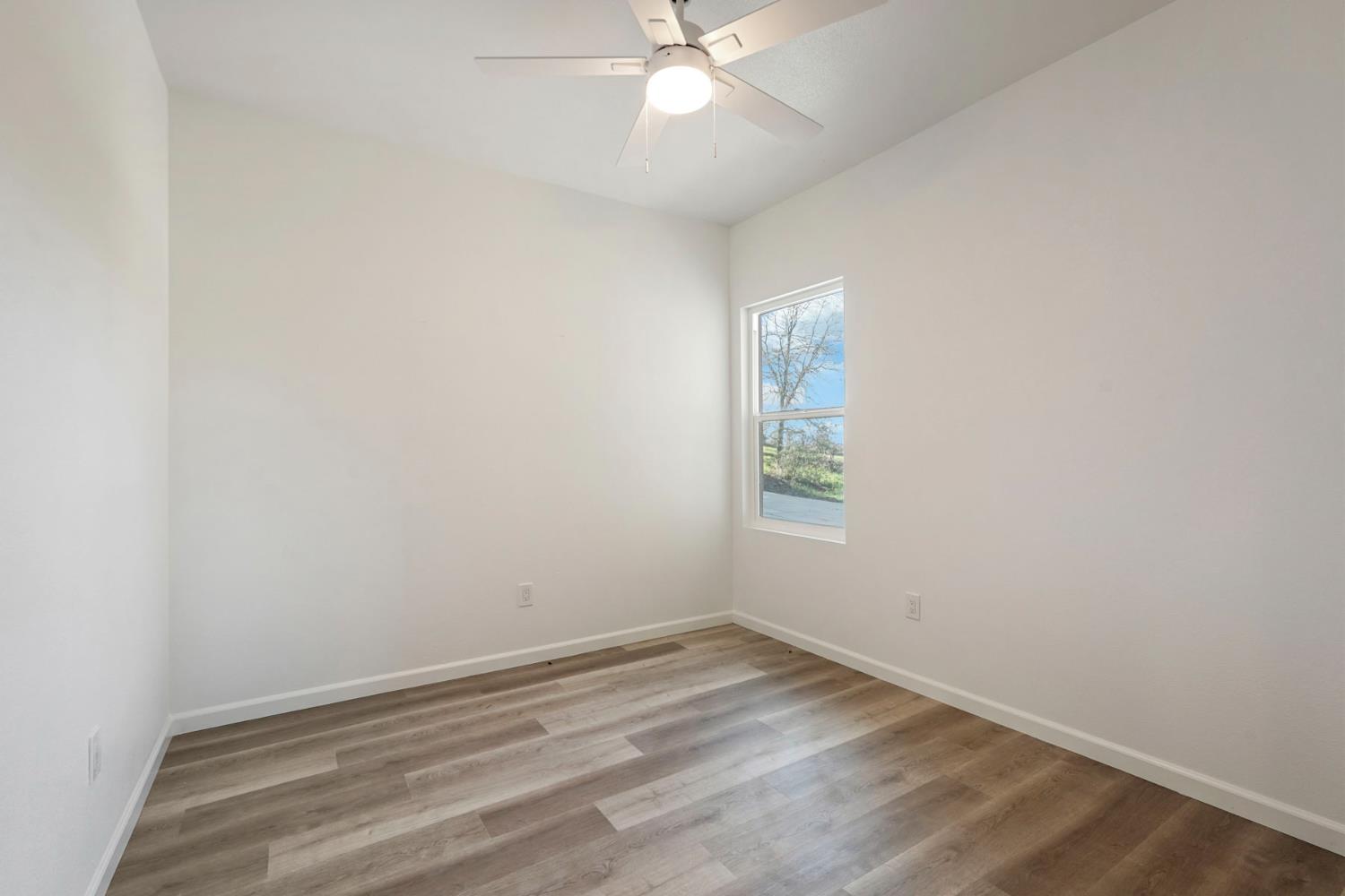 3286 Botfuher Road Valley Springs, CA 95252 - Photo 12 of 24 an empty room with a window and ceiling fan
