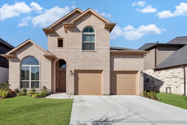 a front view of a house with a yard and garage