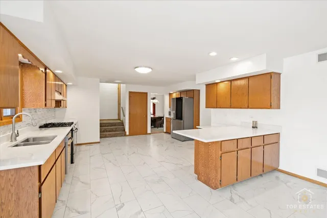 a kitchen with a sink stove and cabinets
