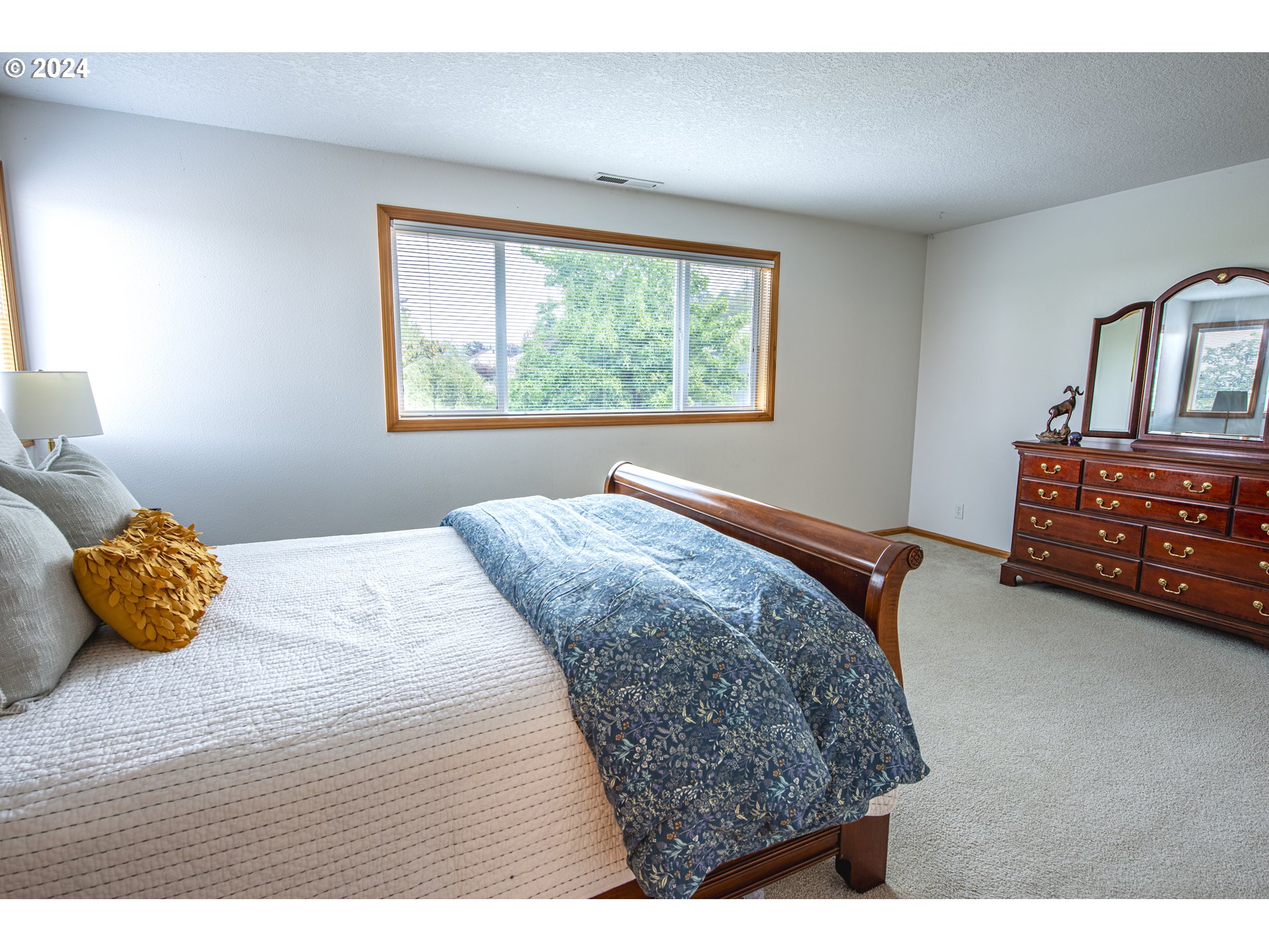 528 Granite Place Springfield, OR 97477 - Photo 24 of 38 a bedroom with a bed a window and dresser