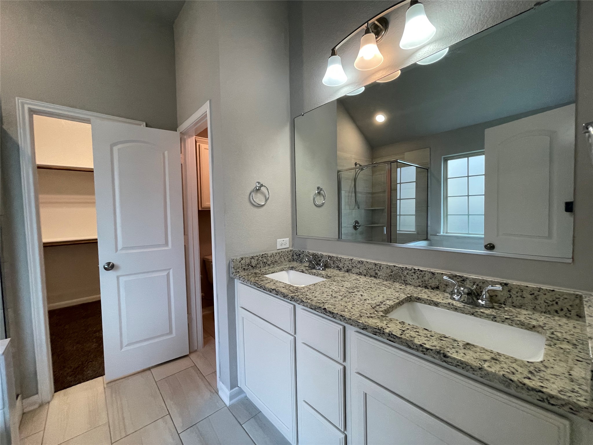 8113 Northgate Loop Temple, TX 76502 - Photo 18 of 35 Dual vanity with granite-style countertops, white cabinetry, and undermount sinks