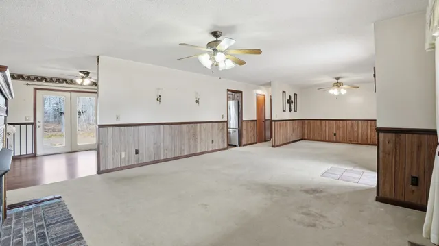 a view of an empty room with window and fireplace