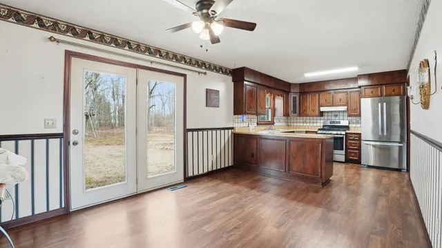 a view of a kitchen with a sink and a large window