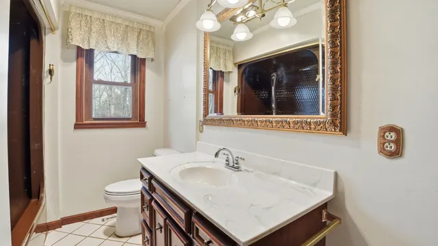 a view of a big room with windows and chandelier fan