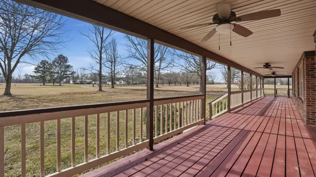 a view of a house with a yard and deck