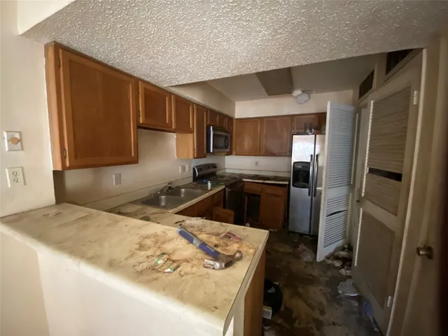 a kitchen with a sink stove and refrigerator