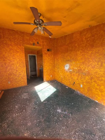 a view of a big room with a ceiling fan