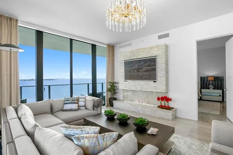 a bedroom with furniture and a large window