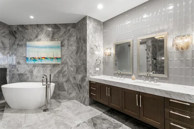 a kitchen with stainless steel appliances granite countertop a sink a stove a refrigerator and island with wooden floor