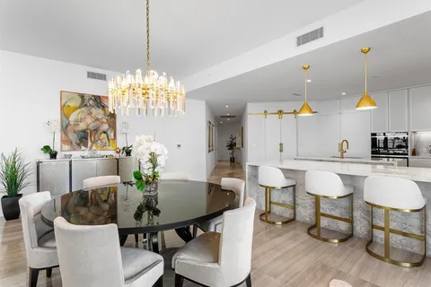 a dining room with furniture window and wooden floor