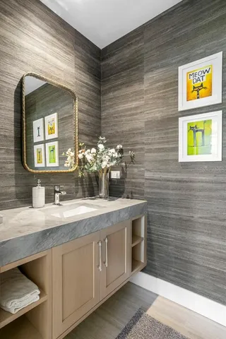 a living room with furniture a clock and a view of bathroom