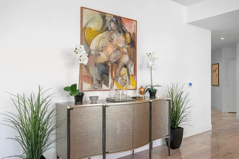 a living room with furniture windows and a table