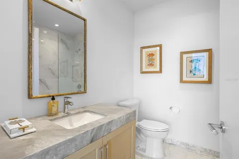 a view of swimming pool with outdoor seating and lake view in back