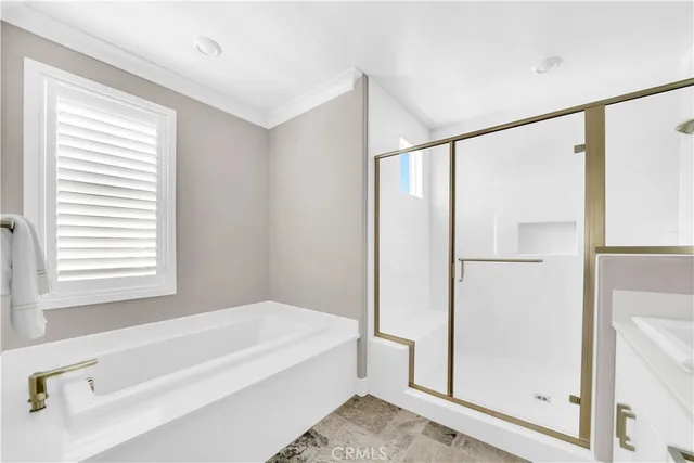 a spacious bathroom with a bathtub and a shower