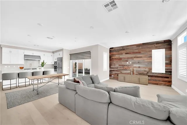 a living room with furniture wooden floor and a large window