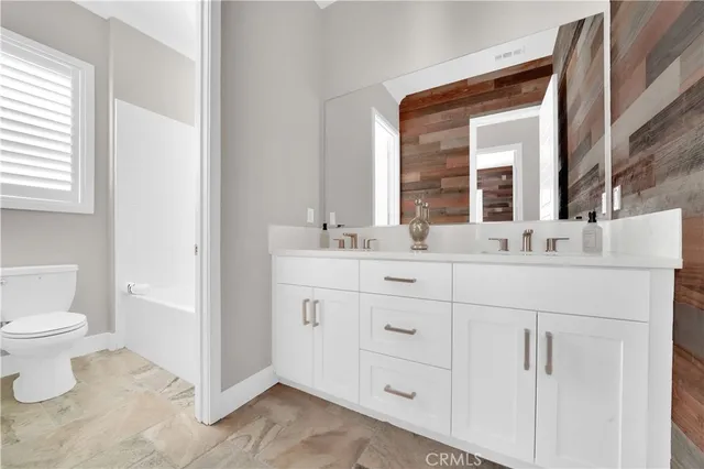 a bathroom with a sink toilet and mirror