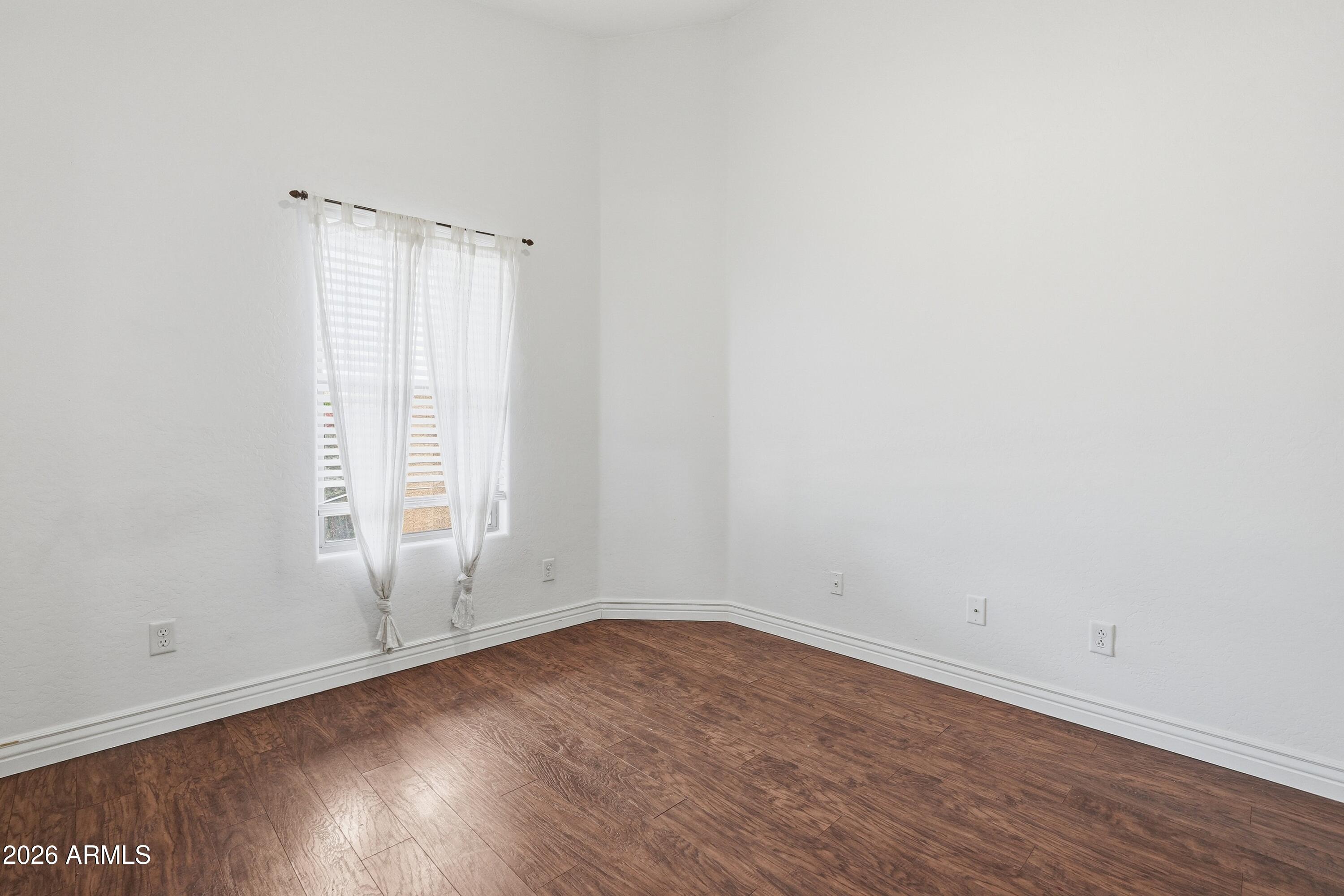 3242 East Bonanza Road Gilbert, AZ 85297 - Photo 19 of 36 an empty room with wooden floor and window