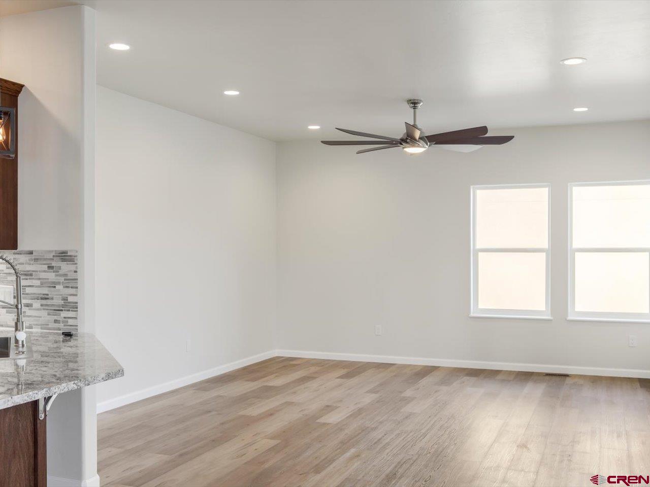 3415 Chestnut Drive Montrose, CO 81401 - Photo 14 of 28 wooden floor in an empty room with a window