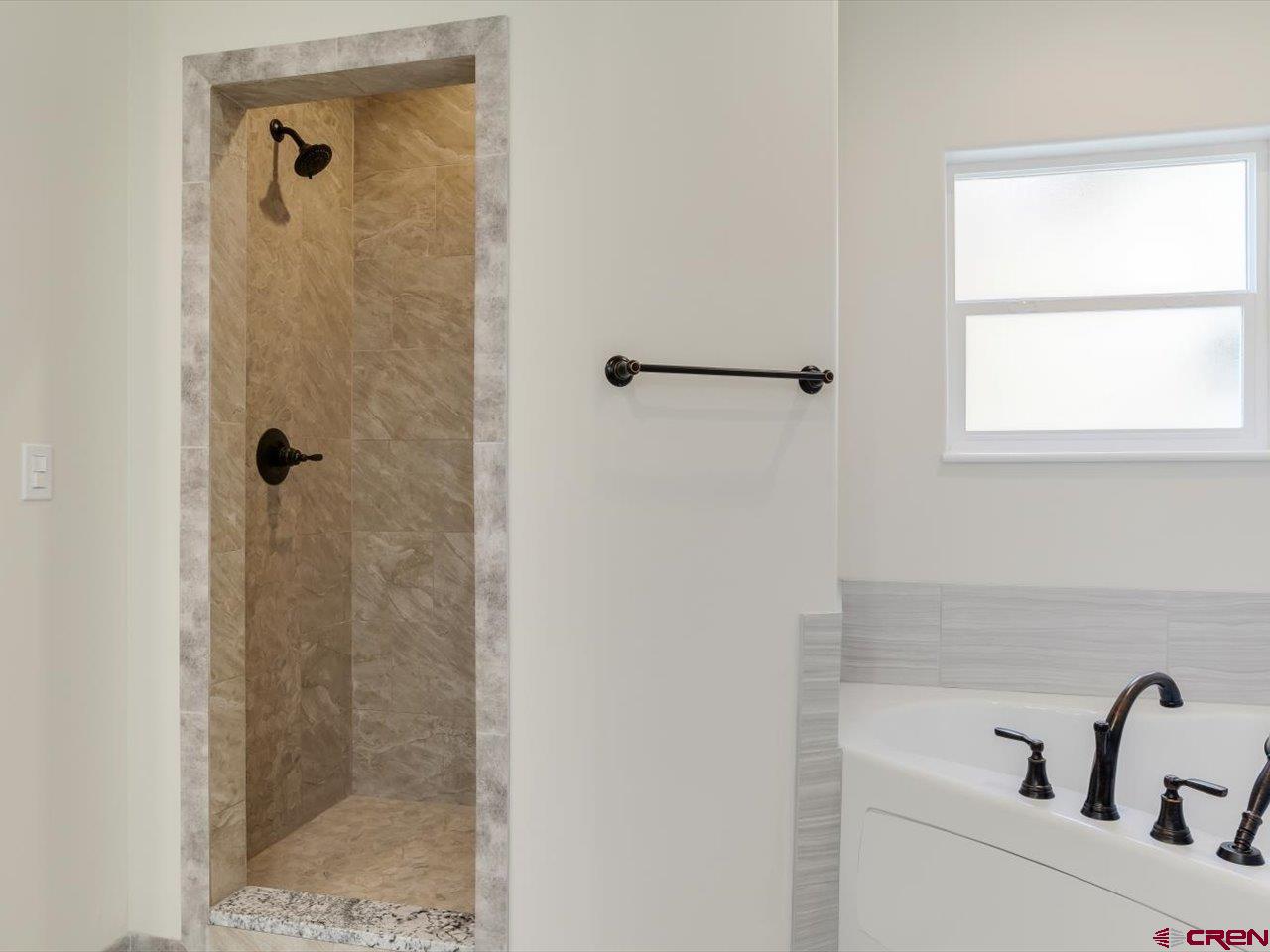3415 Chestnut Drive Montrose, CO 81401 - Photo 19 of 28 a bathroom with a sink and shower