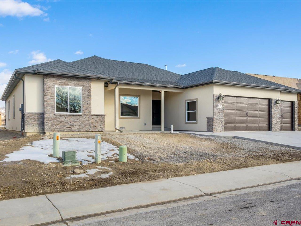3415 Chestnut Drive Montrose, CO 81401 - Photo 2 of 28 a front view of a house with a yard and garage