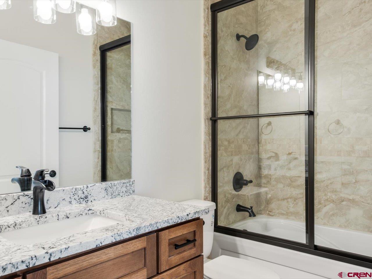 3415 Chestnut Drive Montrose, CO 81401 - Photo 24 of 28 a bathroom with a granite countertop sink and a mirror