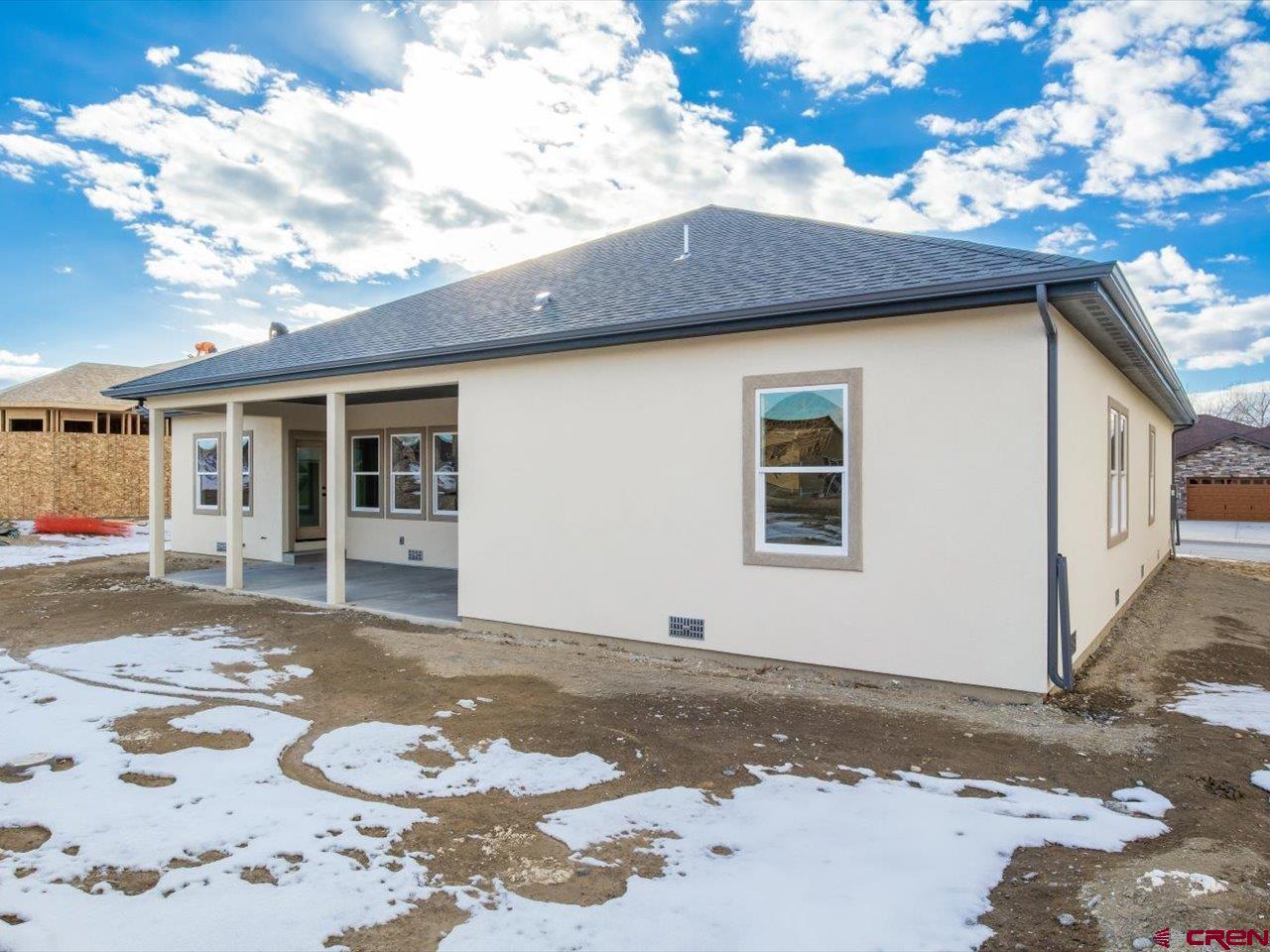 3415 Chestnut Drive Montrose, CO 81401 - Photo 4 of 28 a front view of a house with a snow on the road