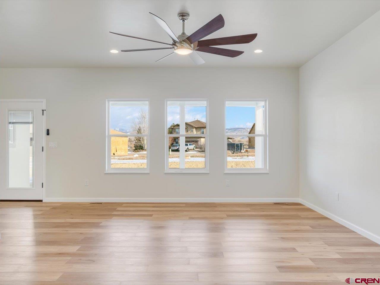 3415 Chestnut Drive Montrose, CO 81401 - Photo 7 of 28 a view of an empty room with wooden floor and a window