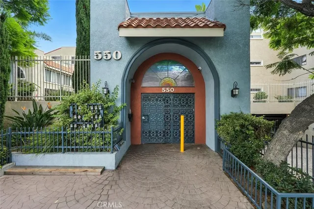 a view of building with potted plants