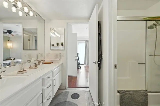a spacious bathroom with a shower sink and mirror
