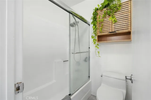 a bathroom with a toilet and a shower