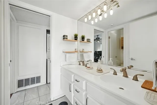 a bathroom with a sink vanity and a mirror