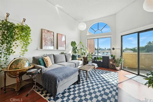 a living room with furniture and a floor to ceiling window