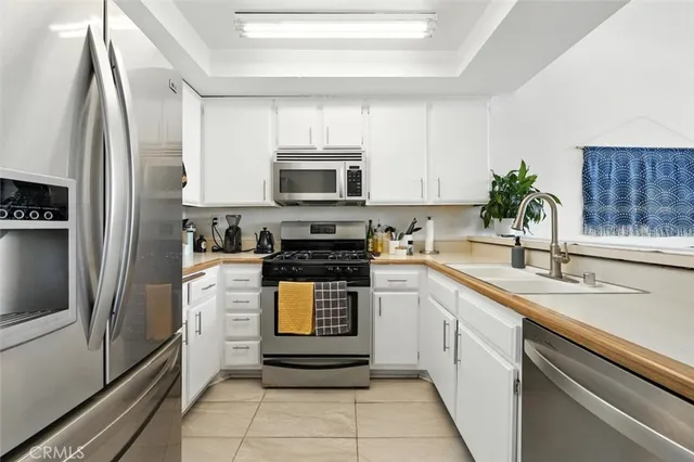 a kitchen with a sink microwave and refrigerator