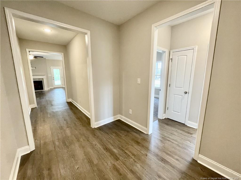 5177 Maxwell Road Stedman, NC 28391 - Photo 8 of 24 a view of a hallway with wooden floor
