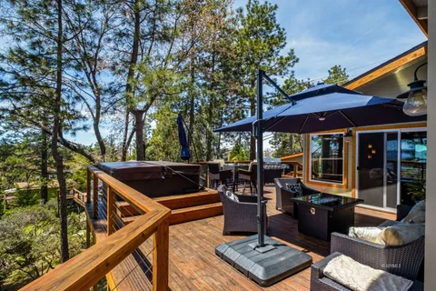 a view of an outdoor sitting area with furniture and umbrella