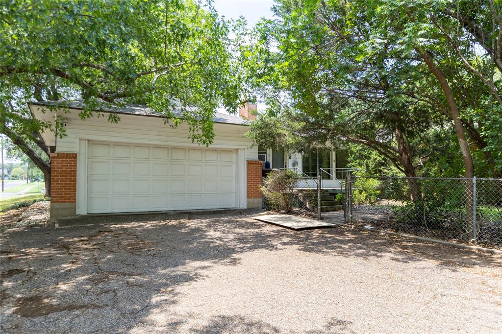 3228 Colcord Avenue Waco, TX 76707 - Photo 28 of 29 Two-car garage with white panel door and brick accents