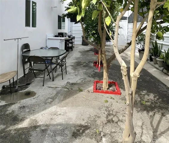 a view of a kitchen with a sink stove cabinets and empty room
