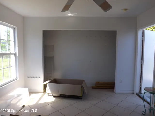 a spacious bedroom with a bed and a window