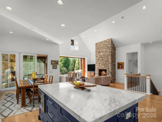 a kitchen with a sink a counter top space and living room area
