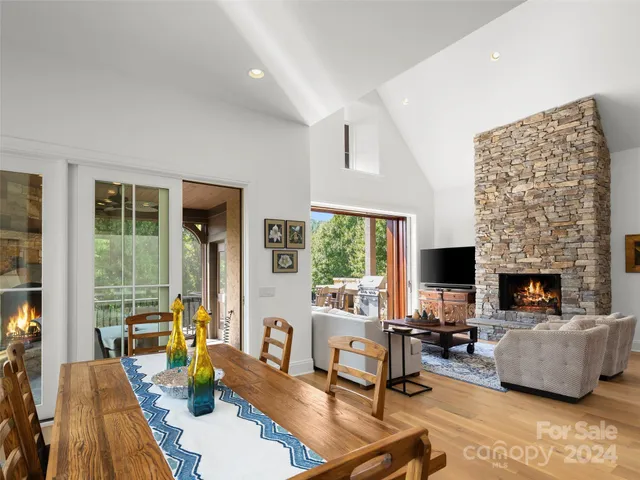 a living room with furniture fireplace and a table