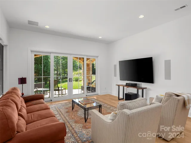 a living room with furniture a rug and a window