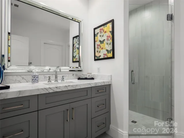 a bed sitting in a bedroom next to a large window